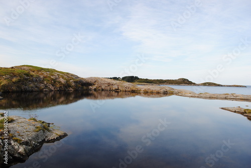 Stunning blue water with rocks and and hill