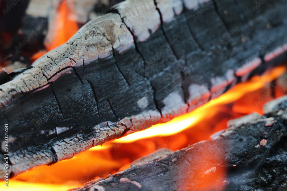 Smoldering coals from the fire. A fading bonfire. Close-up. Texture. Smoldering coals from the fire. A fading bonfire. Close-up. Texture.