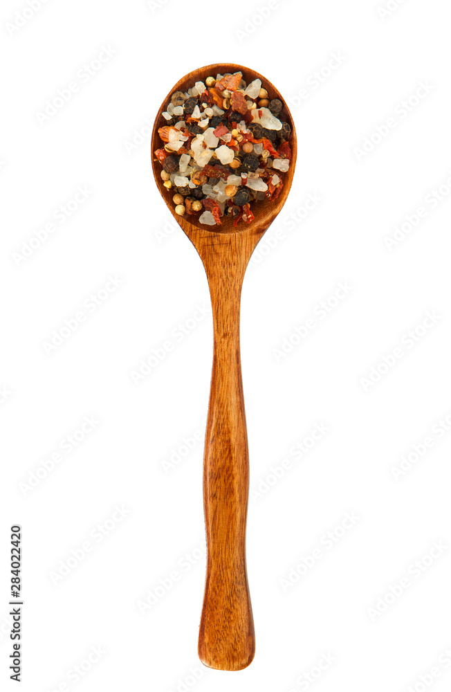 Mix seasonings in a wooden spoon on isolate. Spice in the spoon. View from above. Seasonings on isolate. Mix seasonings in a wooden spoon on isolate. Spice in the spoon. View from above. Seasonings on isolate.