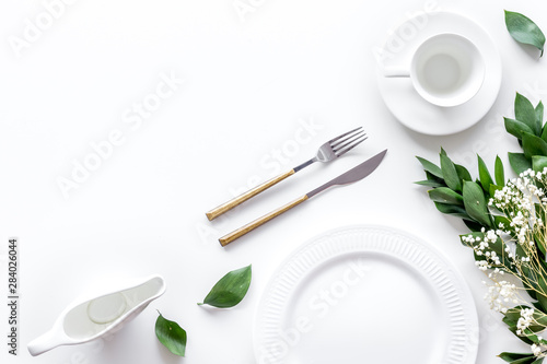 Elegant table setting with plates and tableware on white background top view mock up