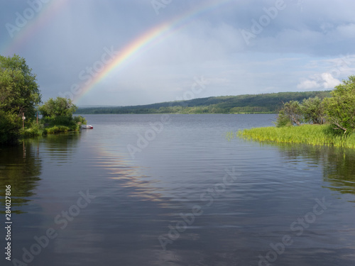 Northern BC calm taiga lake rainbow Canada
