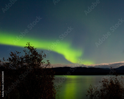 Aurora borealis reflected on Lake Laberge Yukon