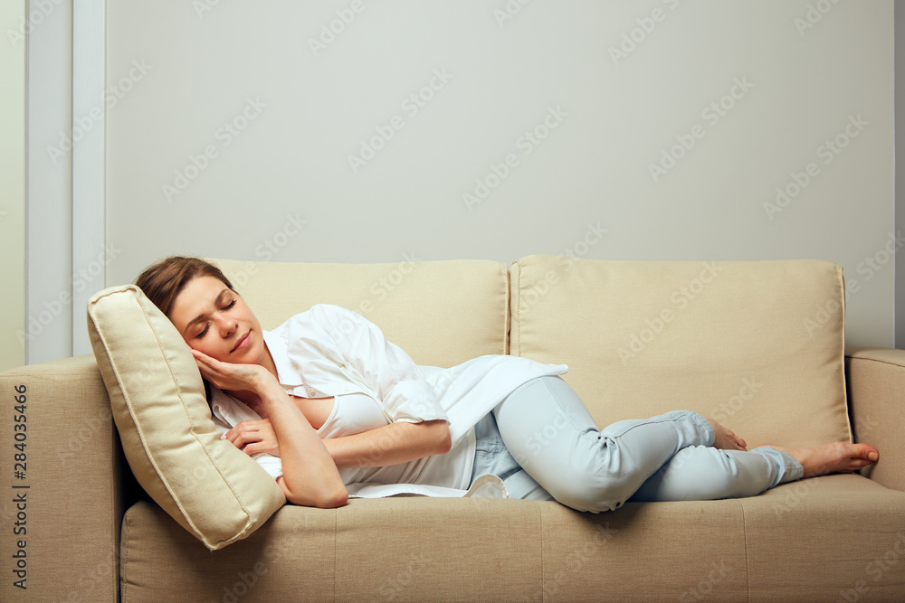 Woman resting lying on the sofa