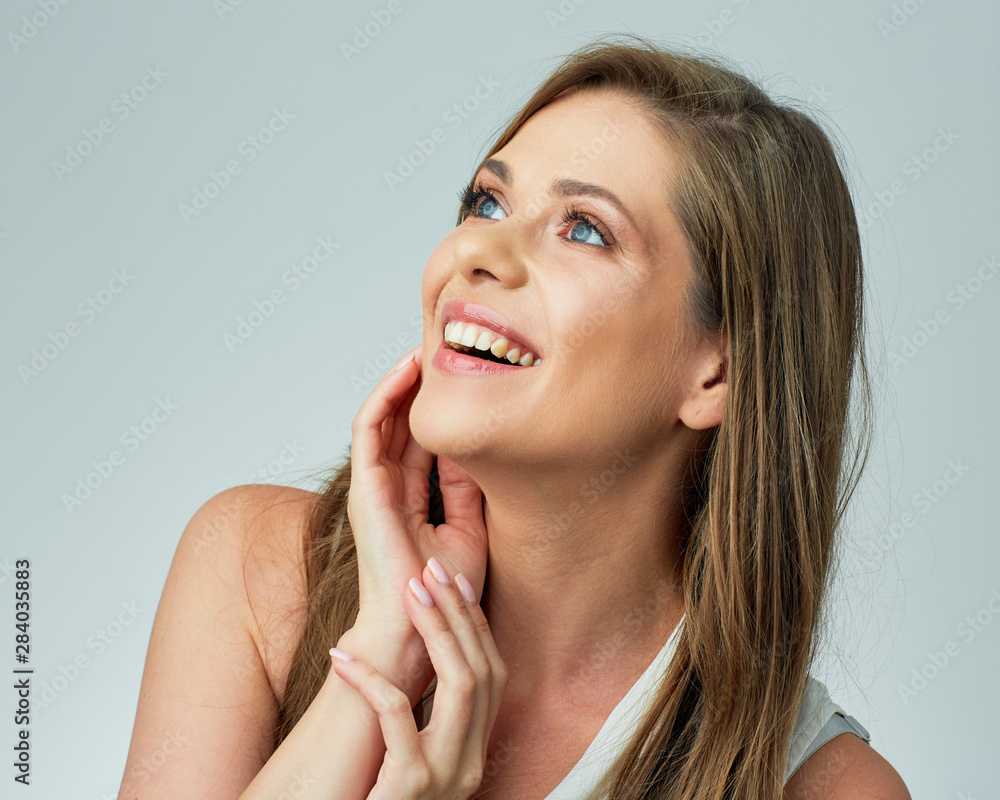 Smiling woman touching her face looking at side. Smiling woman touching her face looking at side.