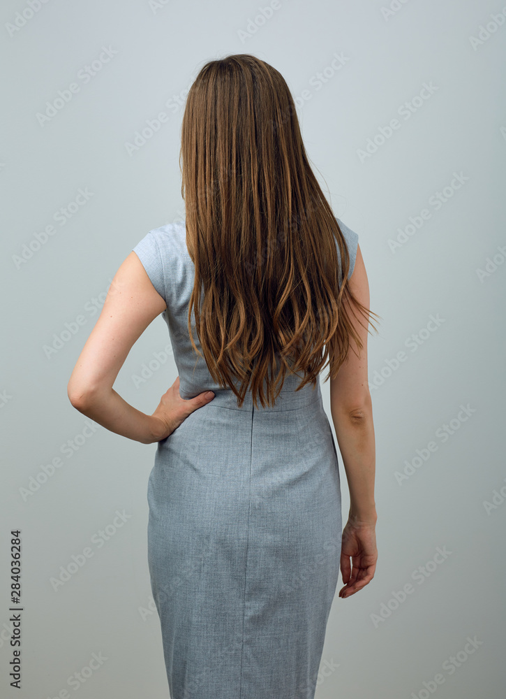 Businesswoman standing back studio portrait Businesswoman standing back studio portrait