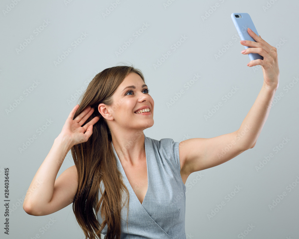 Young smiling woman doing selfie with smart phone. Young smiling woman doing selfie with smart phone.