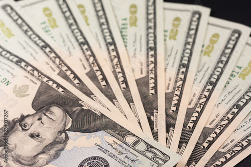 Twenty dollar bill. 20 dollar bill. Image isolated on black background. Fan-shaped tickets introduced in a wallet.