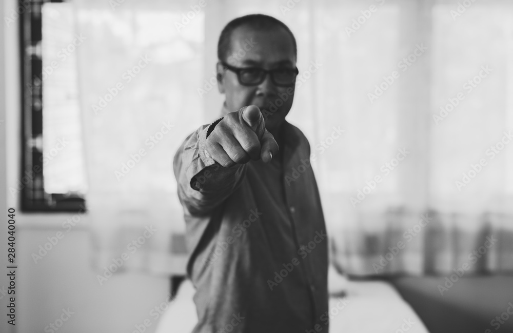 Senior asian man points his finger to you,Close up,Black and white toned,Selective focus Senior asian man points his finger to you,Close up,Black and white toned,Selective focus