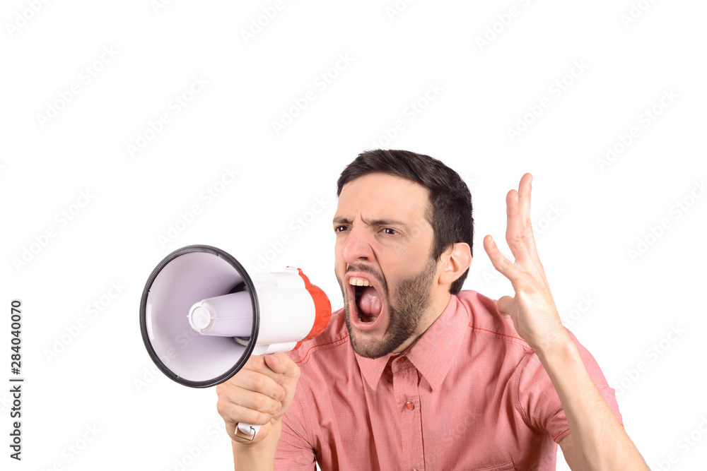 Young man screaming on a megaphone. Young man screaming on a megaphone.