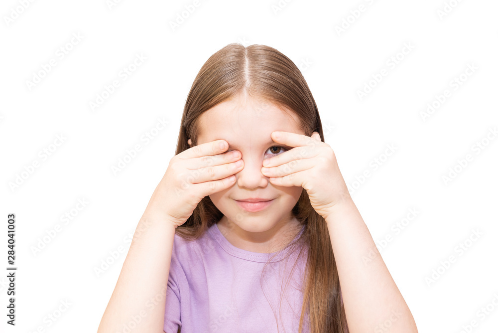 The little girl spies because of palms. It is isolated on a white background. The little girl spies because of palms. It is isolated on a white background.