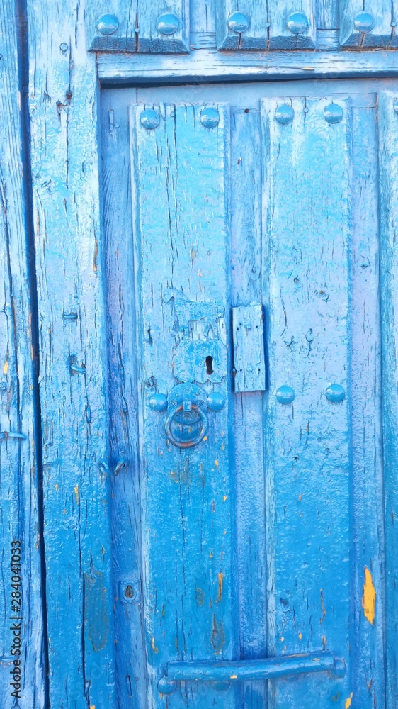 Central part of an old wooden door of an agricultural village in the middle of the Iberian Peninsula, Europe. Blue wood. Central part of an old wooden door of an agricultural village in the middle of the Iberian Peninsula, Europe. Blue wood.