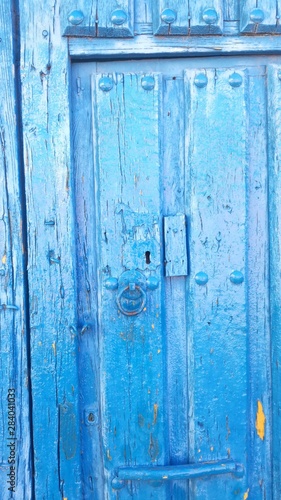 Central part of an old wooden door of an agricultural village in the middle of the Iberian Peninsula, Europe. Blue wood.