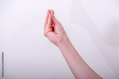 Photography Woman gesturing typical Italian hand gesture, this gesture meaning what are yo