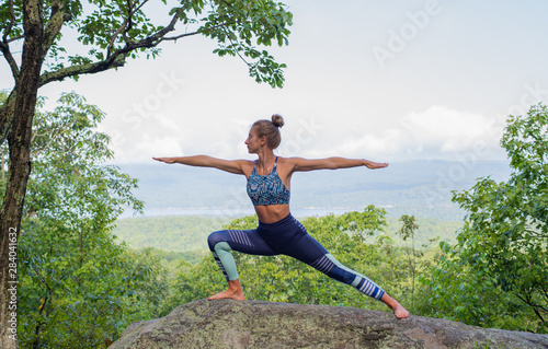 Young woman practicing yoga outdoors harmony with nature.