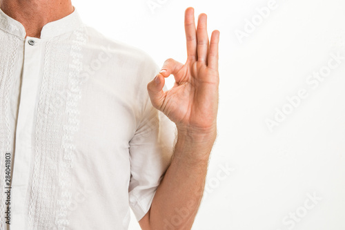 Man performing various yoga hand gestures called "mudras" - Alternative health and wellbeing concept image with copy space for text.