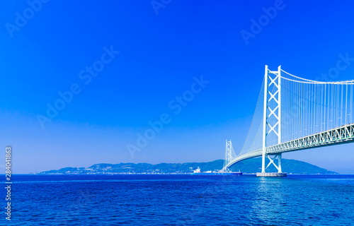 Landscape of Akashi Kaikyo Bridge in the background of blue sky in the summer morning