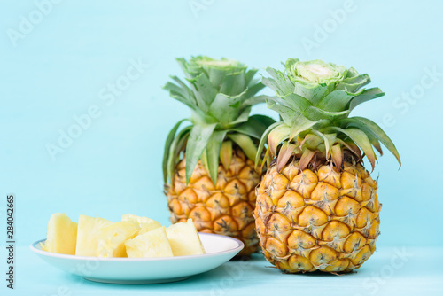 Fresh sliced pineapple on green background, tropical fruit