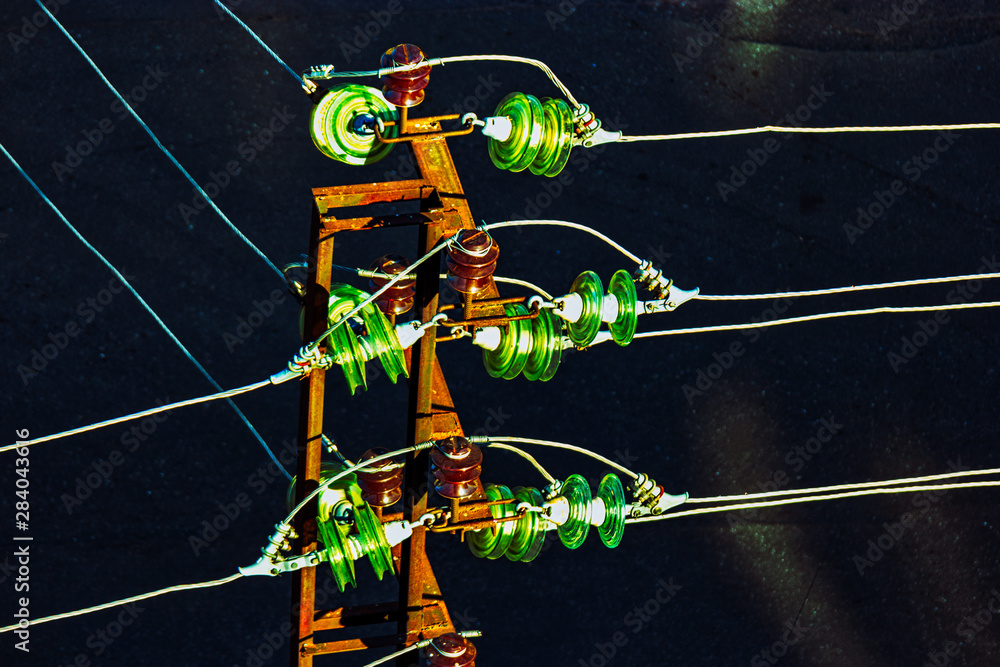 High voltage power tower detail with set of glass electrical insulators ...