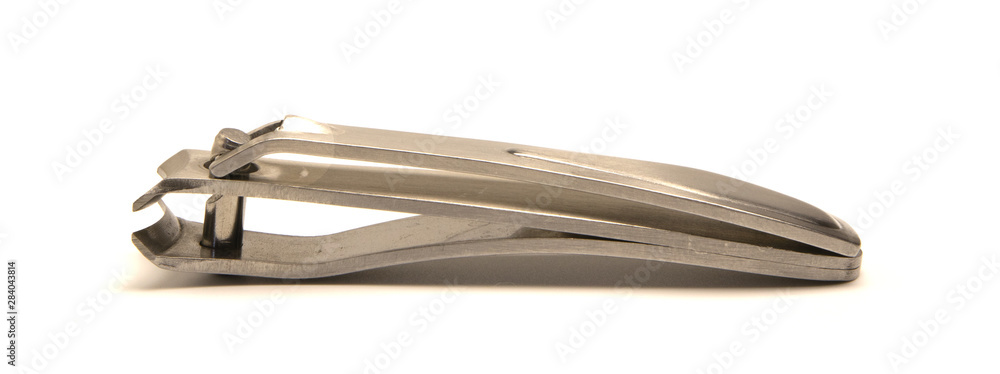 Fototapeta premium metal nail clippers lie on a white background
