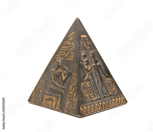 pyramid figurine stands on a white background