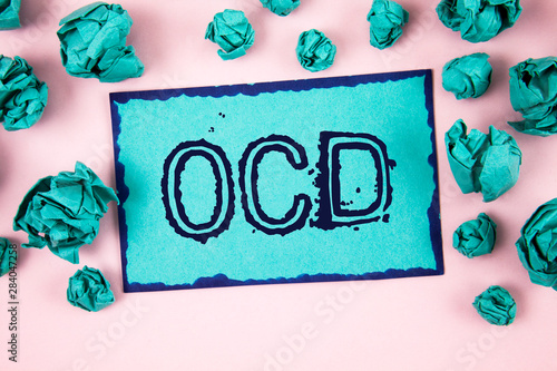 Writing note showing Ocd. Business photo showcasing Obsessive Compulsive Disorder Psychological Illness Medical Condition written Sticky Note paper plain Pink background Paper Balls.