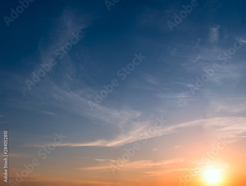 Sunset and colored cirrus clouds on a bright blue sky. © Sviatoslav Khomiakov