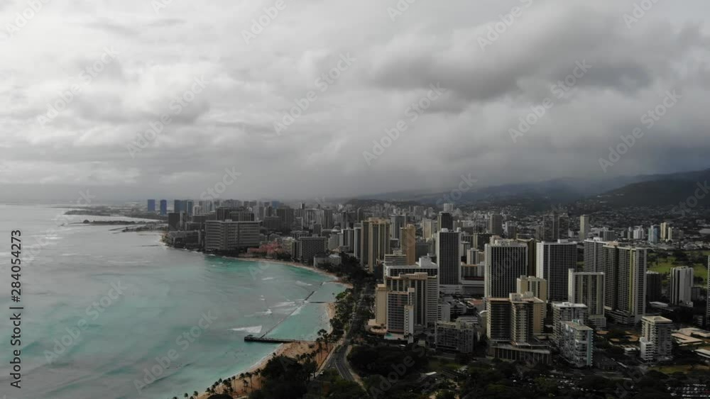 Beautiful Aerial of Waikiki City and Beach on Oahu Hawaii. Scenic view of the towns skyscraper and waves hitting the beach. Beautiful Aerial of Waikiki City and Beach on Oahu Hawaii. Scenic view of the towns skyscraper and waves hitting the beach.