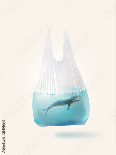 Blue whale  ( toy model)  in a plastic bag.Creative concept background for environmentalism and  plastic awareness.
