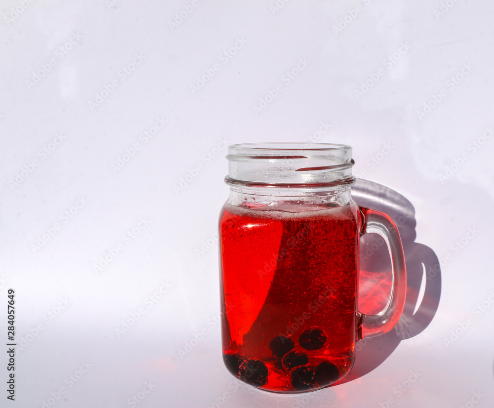 summer berry lemonade in glass jar-mug with lid and straw on white background. summer berry lemonade in glass jar-mug with lid and straw on white background.
