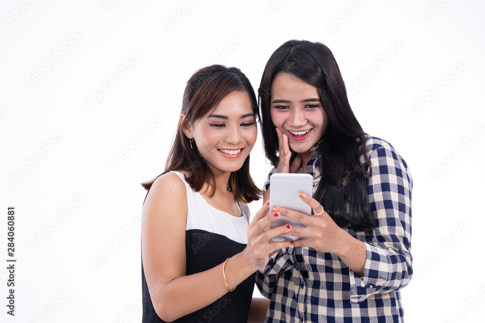 Friends looking at smartphone in an indoor Friends looking at smartphone in an indoor