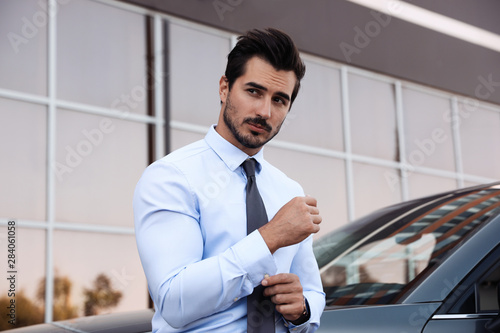 Attractive young man near luxury car outdoors © New Africa