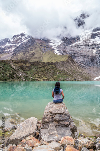woman in front of the Humantay Lake on the Salkantay Trail, the trek to Machu Picchu, Peru