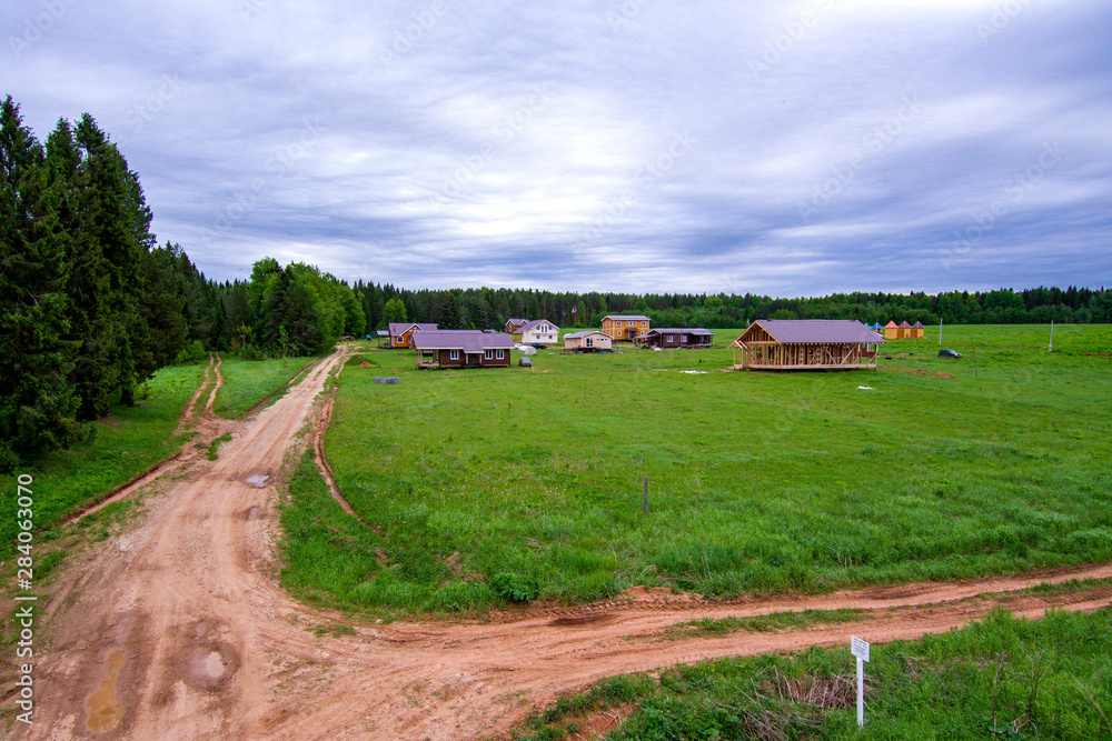 construction of a new village on a field near the forest construction of a new village on a field near the forest