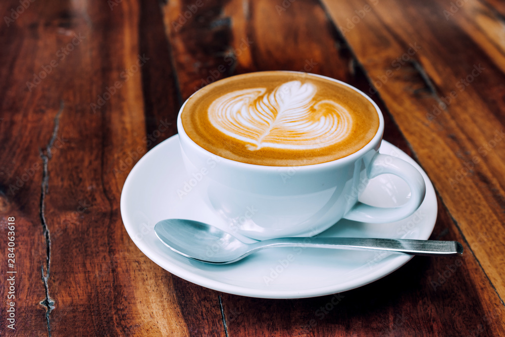 Coffee milk latte on wood table at coffee shop for drink in coffee time Coffee milk latte on wood table at coffee shop for drink in coffee time