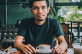 Man sitting in coffee shop for drink in coffee time