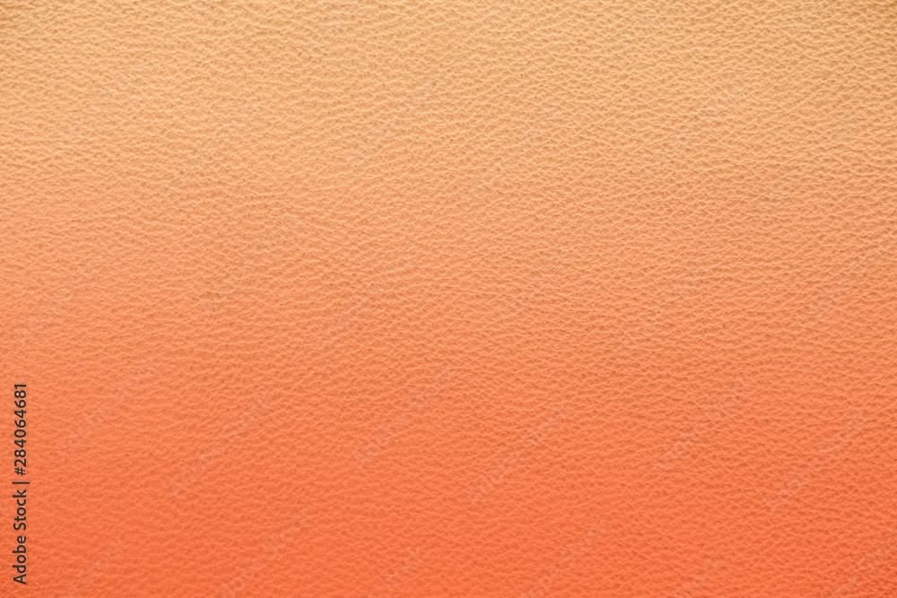 Fototapeta premium Texture of genuine leather. Gentle color leather texture closeup. Colorful background with gradient. Delicate pink color.