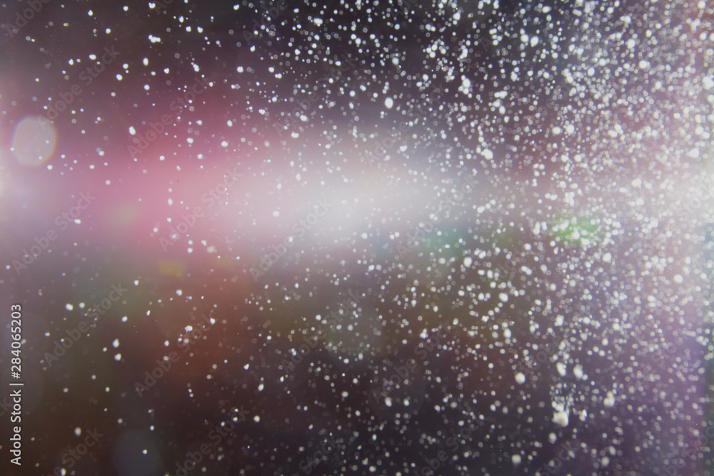 Abstract dust explosion and flash with illumination on a black background