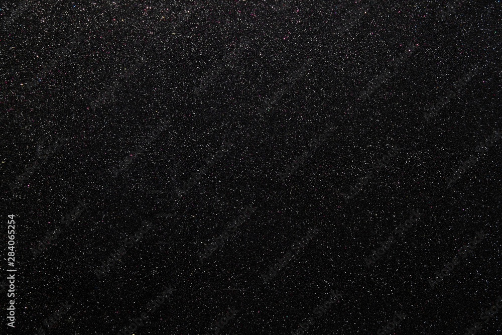 Fototapeta premium Black glitters abstract shiny background. Design paper texture for decoration and design of Christmas, New Year or other holiday pictures. Beautiful packaging material.