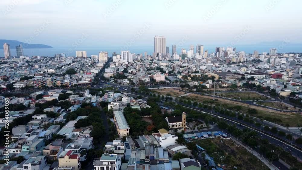 Da nang, Vietnam Panoramic Sunset Time Lapse from rooftop looking across urban area to city beach, resorts, sea and distant headland. Light changes from sunny to evening Da nang, Vietnam Panoramic Sunset Time Lapse from rooftop looking across urban area to city beach, resorts, sea and distant headland. Light changes from sunny to evening