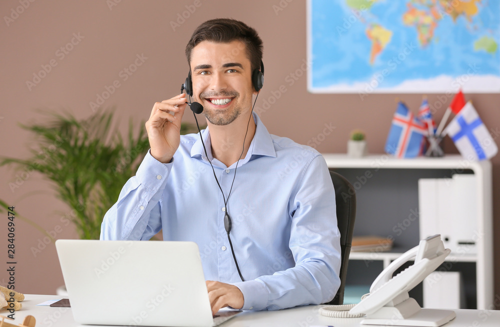 Male travel agent working in office Male travel agent working in office