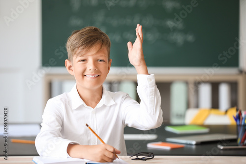 Cute little pupil raising h...