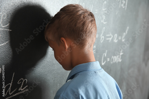 Annoyed little schoolboy ne...