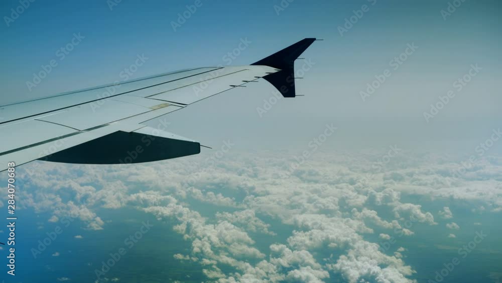 Aeroplane. View of airplane wing of aircraft flying above the clouds. 4K Aeroplane. View of airplane wing of aircraft flying above the clouds. 4K