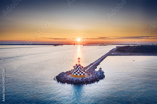 Punta Sabbioni Lighthouse at Mediterranean Sea in Italy photo