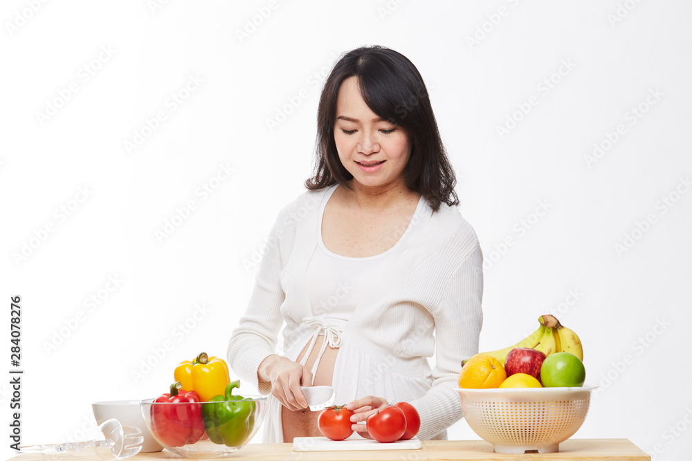 Belly women prepare food on the table.