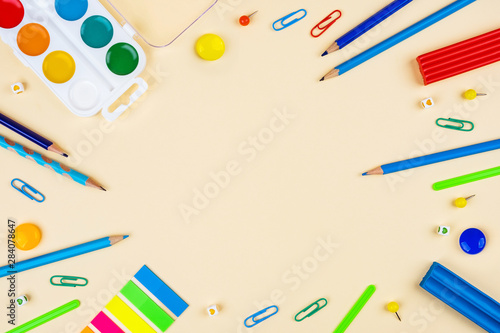 School accessories on a yellow background. Pastel colored.