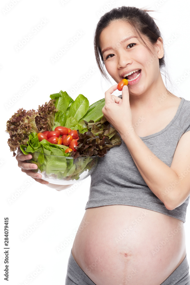 A portrait of a Happy pregnant woman with a bowl of salad A portrait of a Happy pregnant woman with a bowl of salad