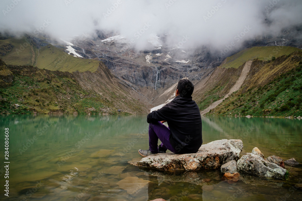 man in front of the Humantay Lake on the Salkantay Trail, the trek to Machu Picchu, Peru man in front of the Humantay Lake on the Salkantay Trail, the trek to Machu Picchu, Peru