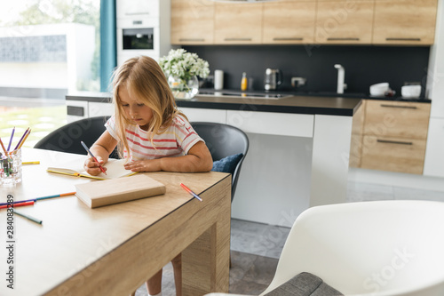 Calm girl writing in notebook stock photo