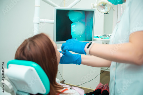 Beautiful girl in a chair at the dentist. Medical office. Dental examination. Dental treatment. Doctor and patient